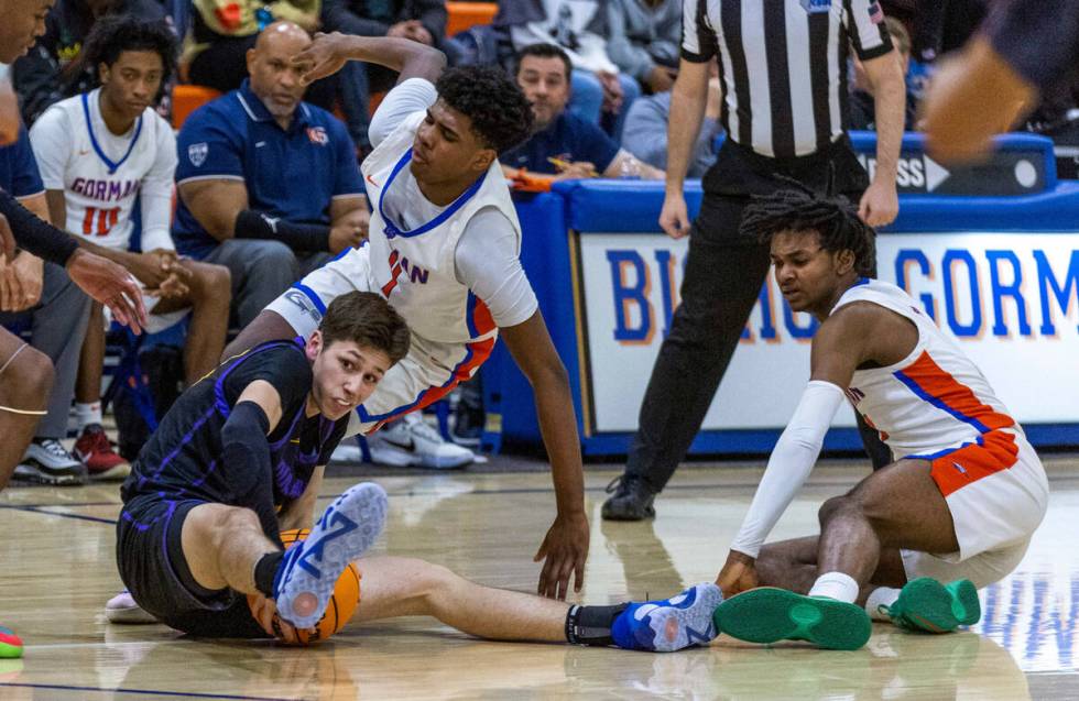 Durango's Colton Kroll (13) grabs a loose ball as Bishop Gorman's Jase Richardson (4) with team ...