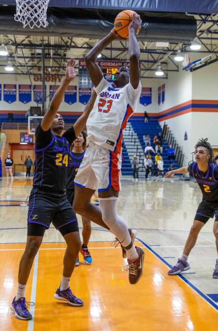 Bishop Gorman's Chris Nwuli (23) elevates for a shot over Durango's Taj Degourville (24) durin ...