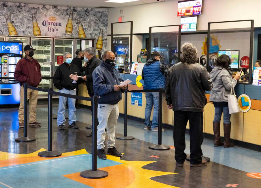 People line up inside The Lotto Store at Primm as they wait to buy Mega Millions and Powerball ...