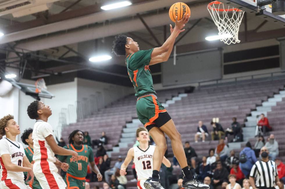 Mojave's C.J. Shaw (3) lays up the ball against Las Vegas during the first half of a basketball ...