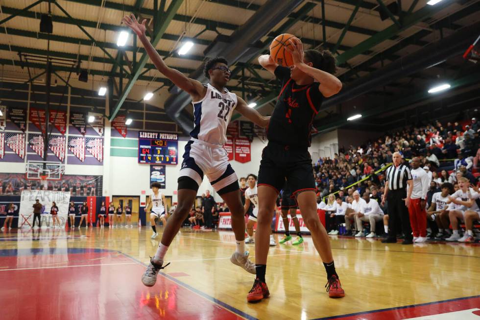 Liberty's Javares Reid (22) defends against Coronado's JC Brooks (4) during a boys class 5A sou ...