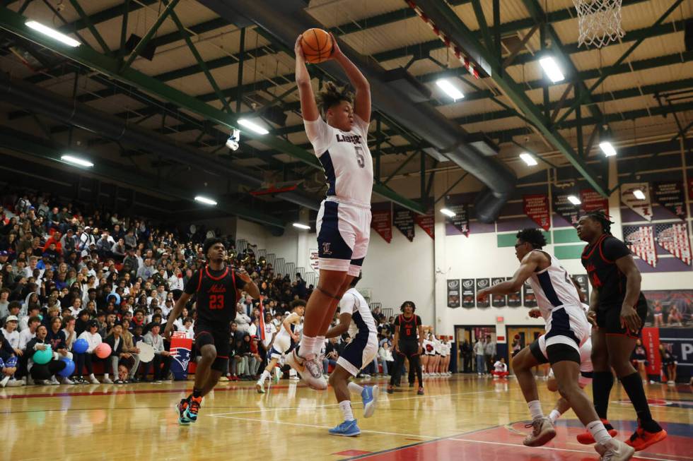 Liberty's Andre Porter (5) grabs a rebound during a boys class 5A southern region semifinal gam ...