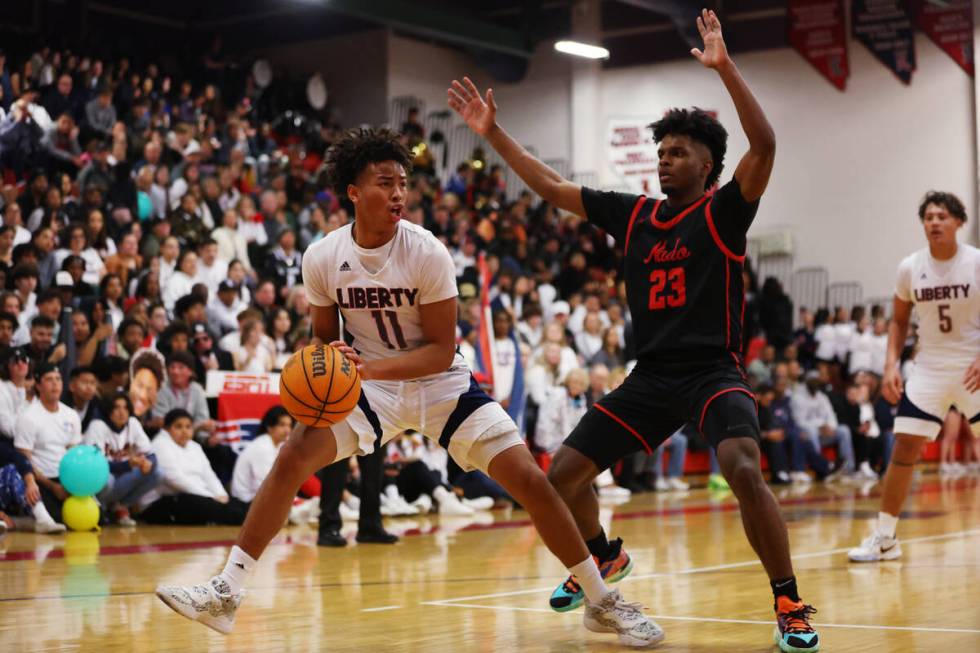 Liberty's Dedan Thomas (11) looks for an open play under pressure from Coronado's Josiah Cunnin ...