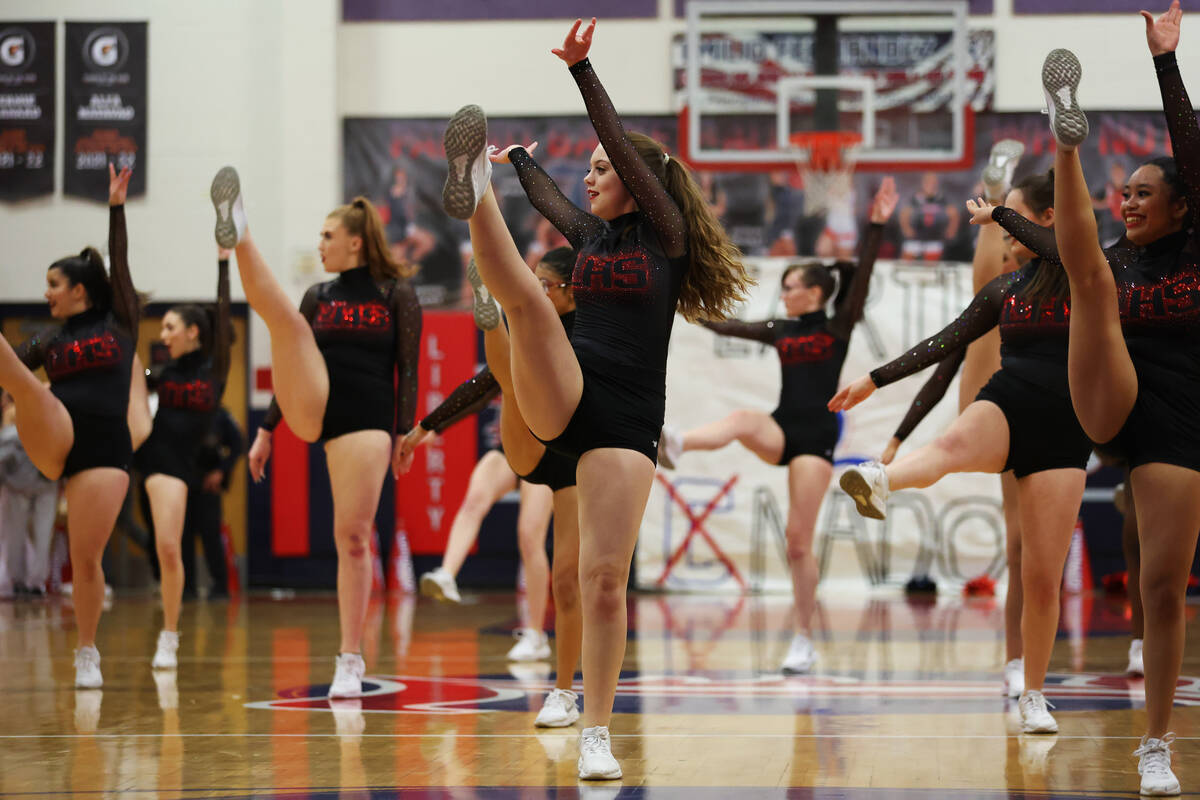 Dancers perform during a boys class 5A southern region semifinal game between Liberty and Coron ...