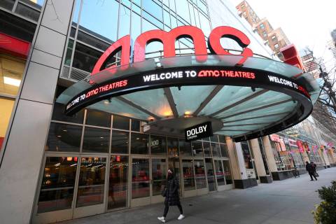 A pedestrian walks by the newly reopened AMC 34th Street theater on March 5, 2021, in New York. ...