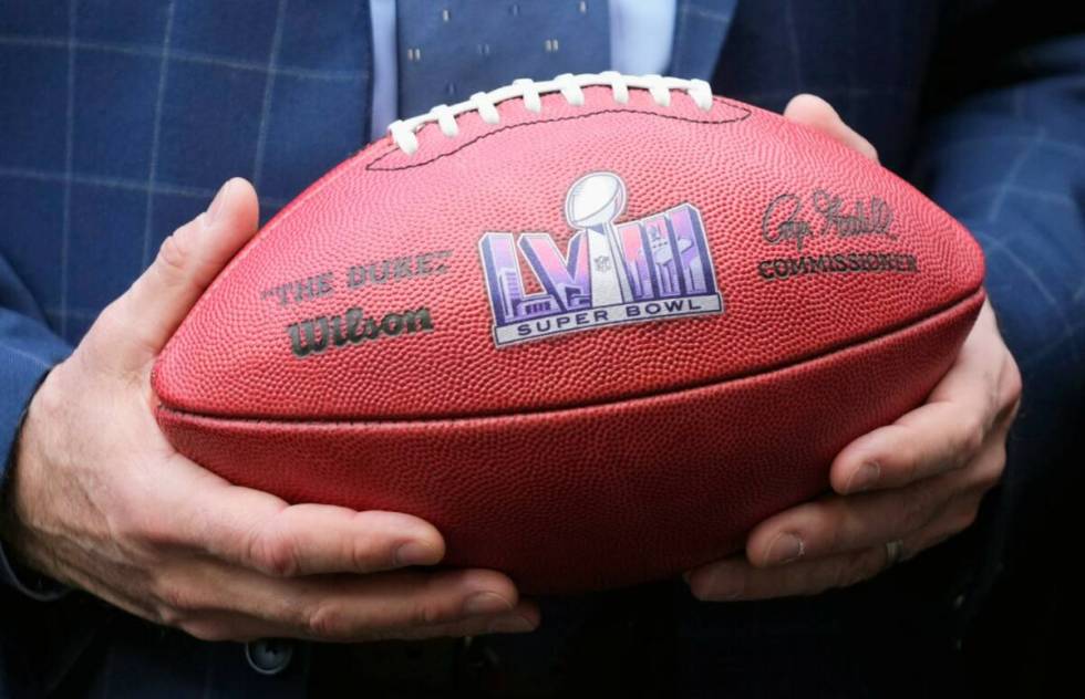 Nevada Gov. Joe Lombardo holds a football during a news conference in Phoenix on Monday, Feb. 1 ...