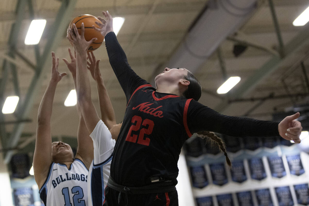 Centennial’s Ayla Williams (12) and Charlece Ohiaeri, obscured at center, jump for a rebound ...