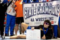 Bishop Gorman’s Kage Mir takes center stage while posing for photos with his team after ...
