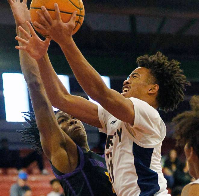 Liberty's Dedan Thomas (11) attempts a jump shot as Durango's Tylen Riley (10) defends during t ...