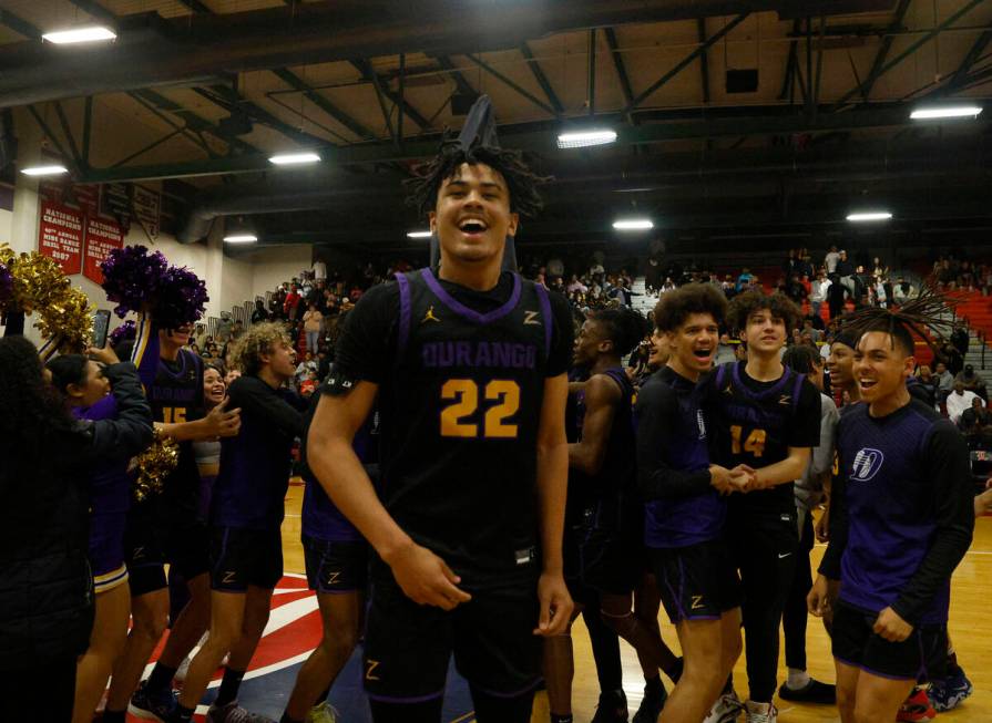 Durango High School players including Michael Bartlett (22) celebrate their 65-59 victory again ...