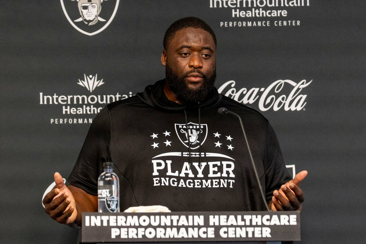 Raiders defensive line coach Frank Okam responds to questions during a news conference followin ...