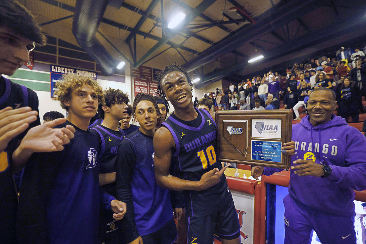 Durango High School players including Tylen Riley (10) celebrate their 65-59 victory against Li ...