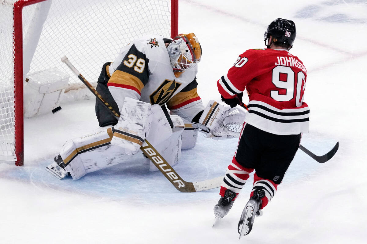 Vegas Golden Knights goaltender Laurent Brossoit, left, can't make a save a goal hit by Chicago ...