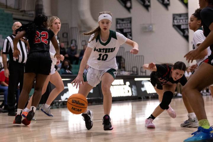 Palo Verde’s Reagan Nehls (10) drives toward the hoop while Las Vegas’ Layla Faug ...