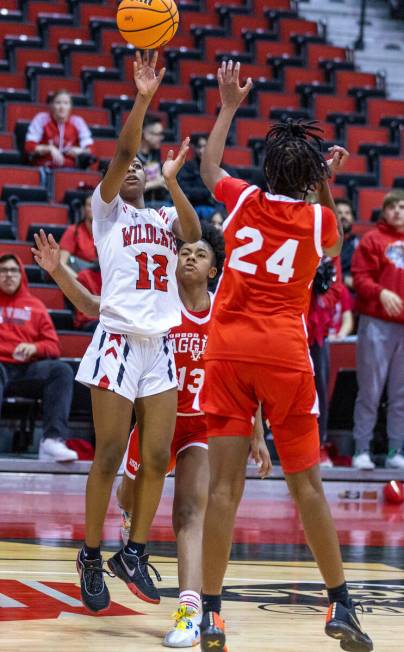 Las Vegas' Jaidyn Savoy (12) shoots over Arbor View's Sanai Branch (24) during the second half ...