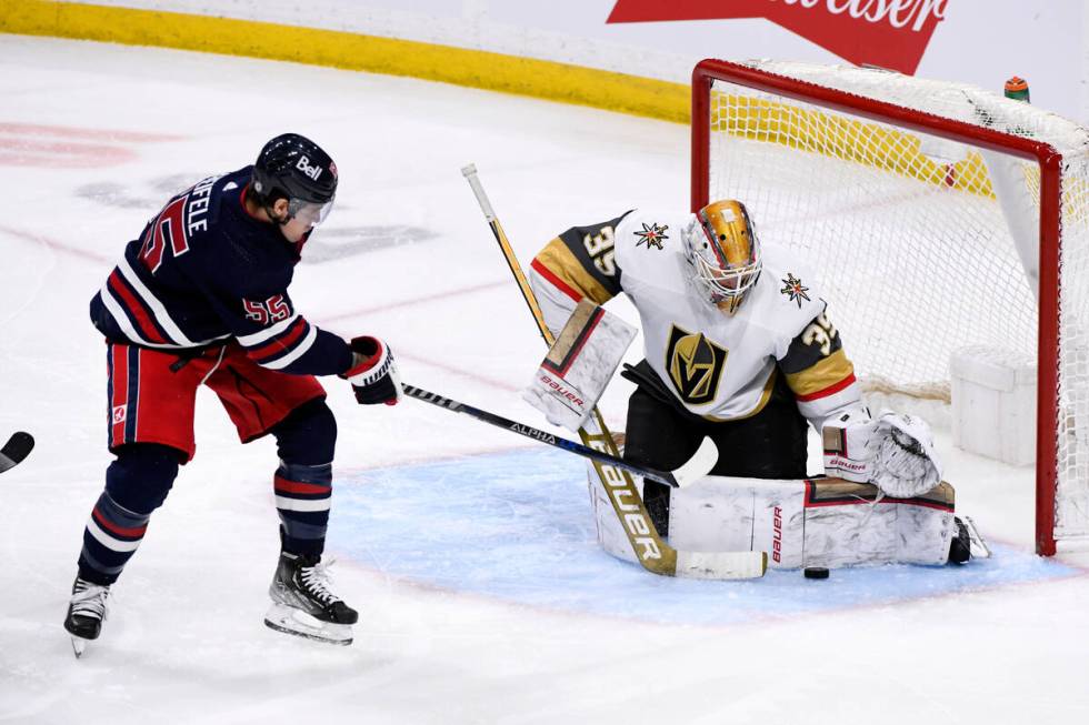 Vegas Golden Knights goaltender Laurent Brossoit (39) makes a save on Winnipeg Jets' Mark Schei ...