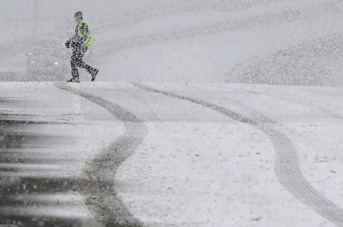 A pedestrian walks across the Highway 38 overpass above I-15 in the California Cajon Pass on Th ...