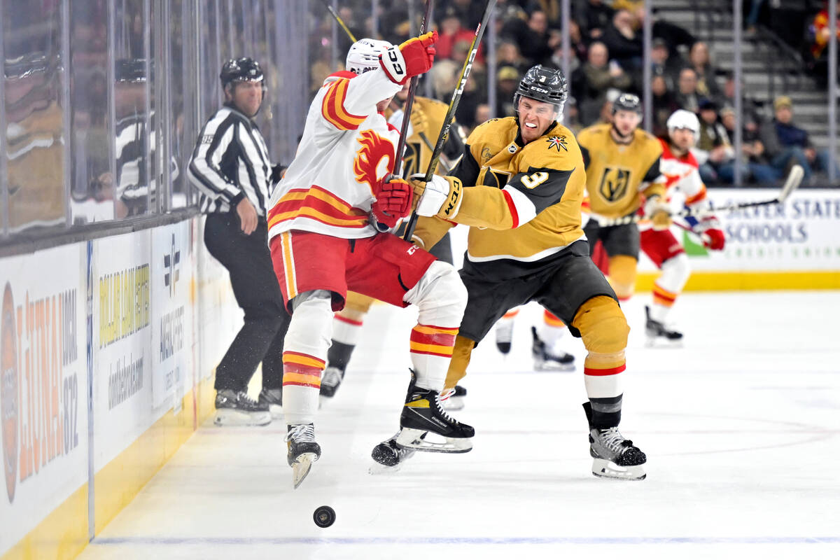 Calgary Flames right wing Walker Duehr, front left, and Vegas Golden Knights defenseman Brayden ...