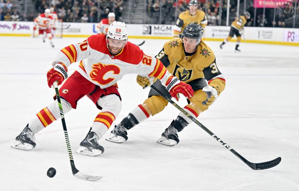 Calgary Flames center Blake Coleman (20) and Vegas Golden Knights defenseman Brayden McNabb (3) ...