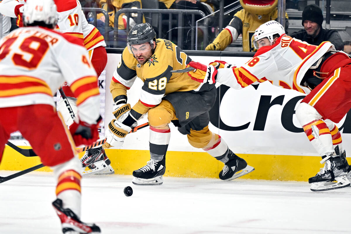 Vegas Golden Knights left wing William Carrier (28) battles for the puck against the Calgary Fl ...