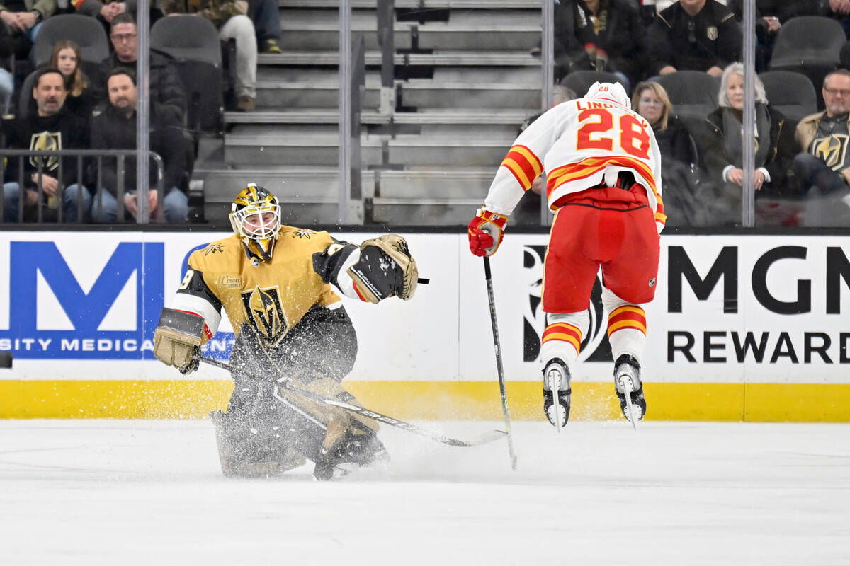 Vegas Golden Knights goaltender Laurent Brossoit (39) and Calgary Flames center Elias Lindholm ...