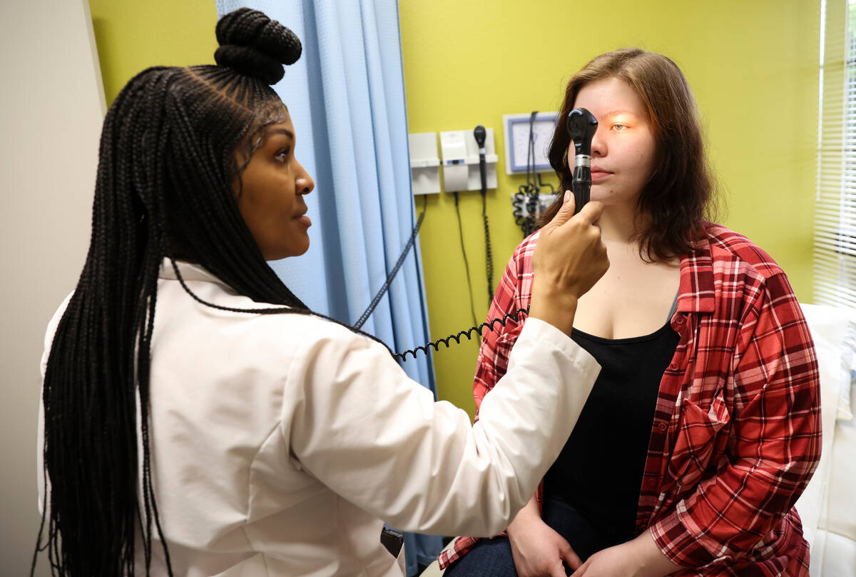 Lilnetra Grady, chief medical officer at FirstMed Health and Wellness Center, checks on patient ...