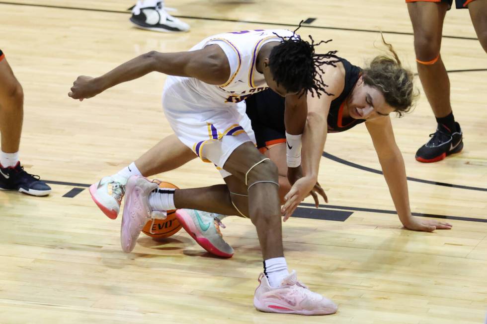 Durango's Tylen Riley (10) and Douglas' Thomas McDowell (25) fight for a loose ball during a bo ...