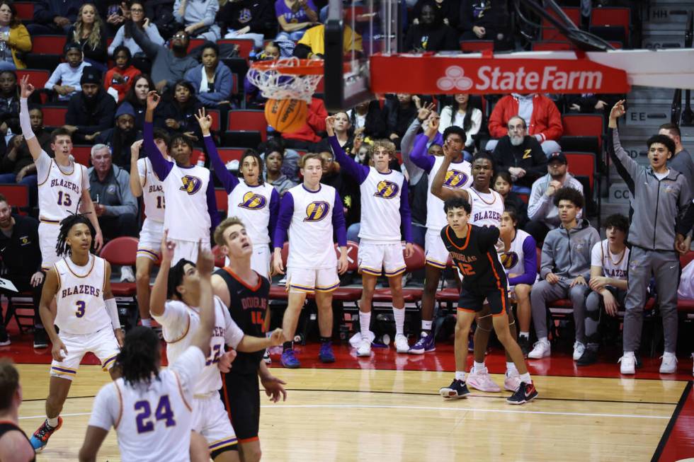 Durango's Tylen Riley (10) shoots a 3-point-shot for a score as Douglas' Jeremiah Pitts (12) lo ...