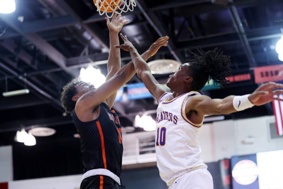 Durango's Tylen Riley (10) defends a shot by Douglas' Theo Reid (10) during a boys class 5A st ...