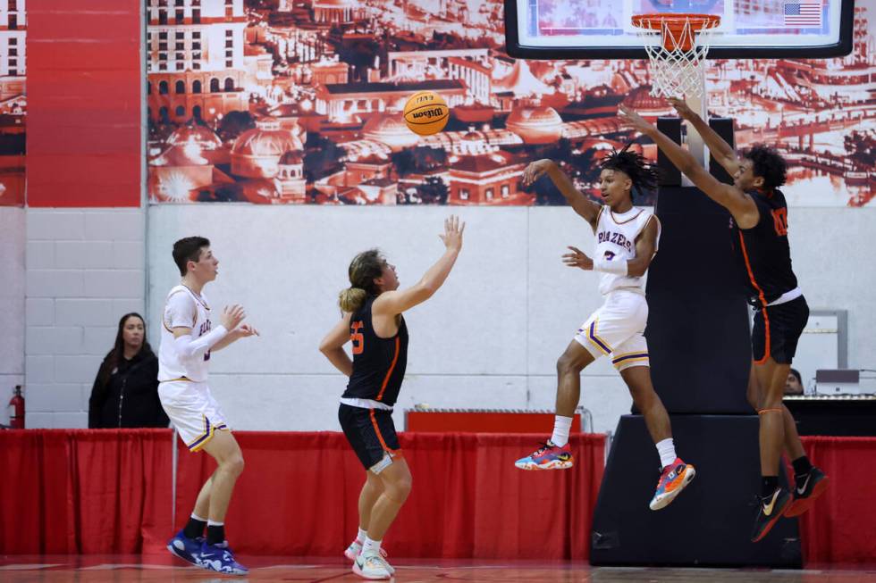 Durango's Jevon Yapi (3) makes a pass under pressure from Douglas' Theo Reid (10) during a boys ...