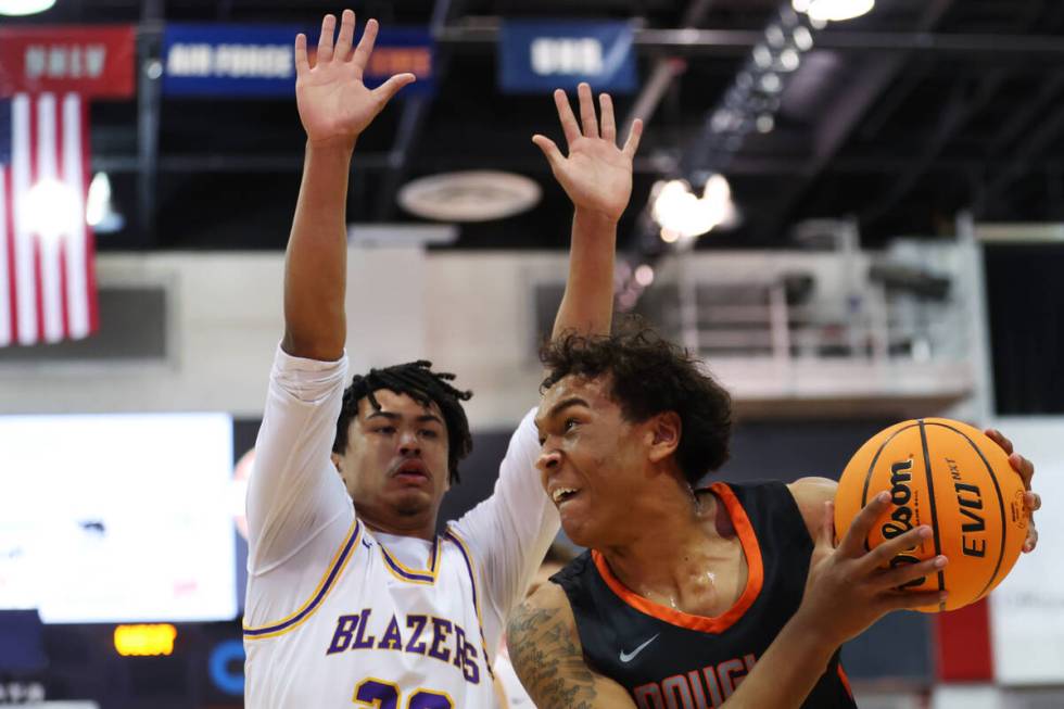 Durango's Michael Bartlett (22) defends against Douglas' Theo Reid (10) during a boys class 5A ...