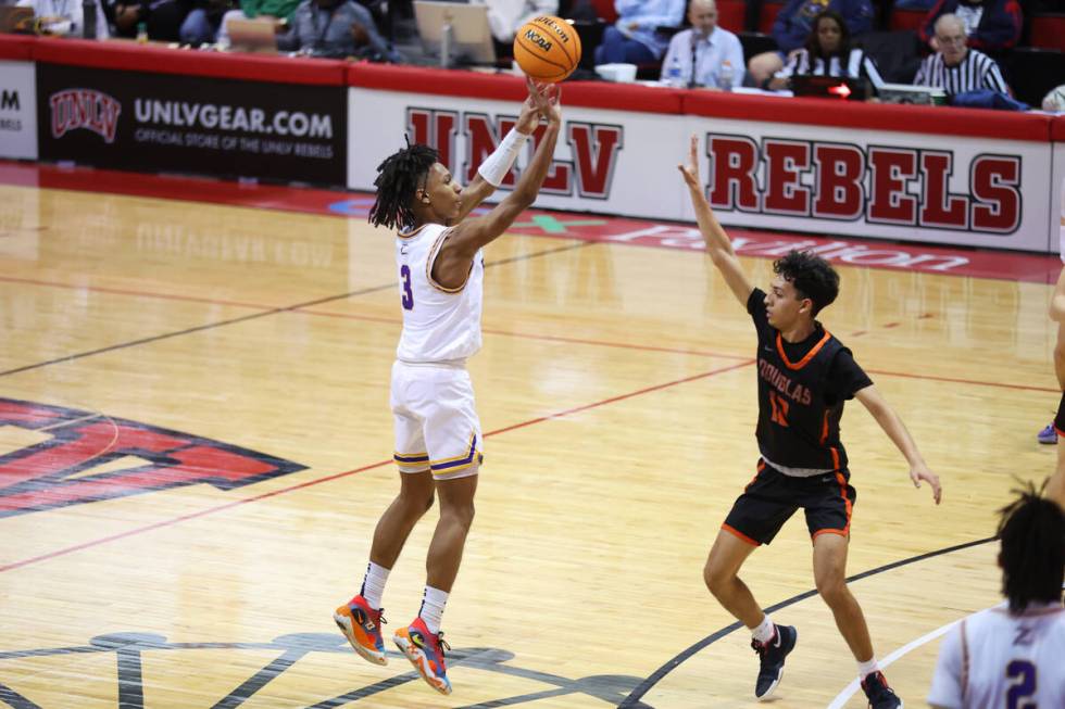 Durango's Jevon Yapi (3) takes a shot under pressure from Douglas' Jeremiah Pitts (12) during a ...