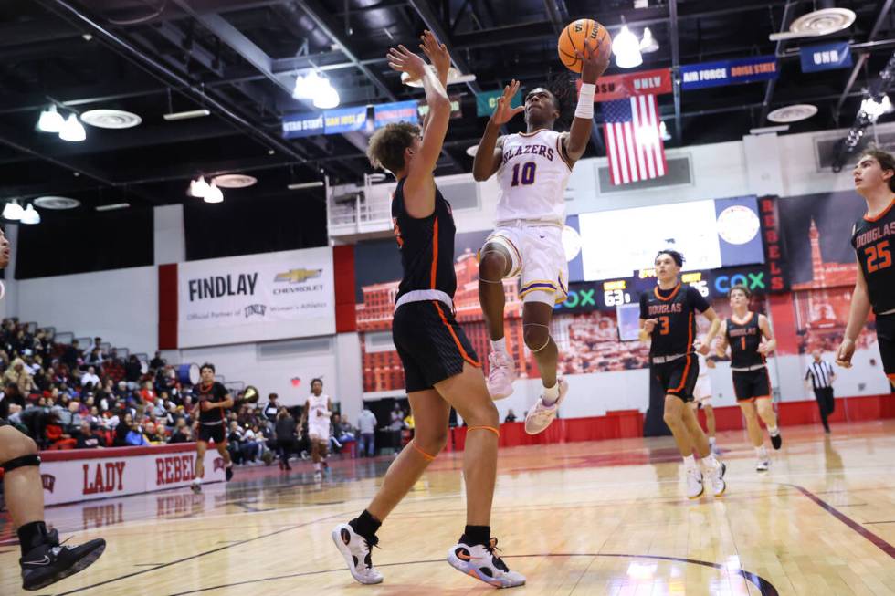 Durango's Tylen Riley (10) takes a shot under pressure from Douglas' Trace Estes (14) during a ...