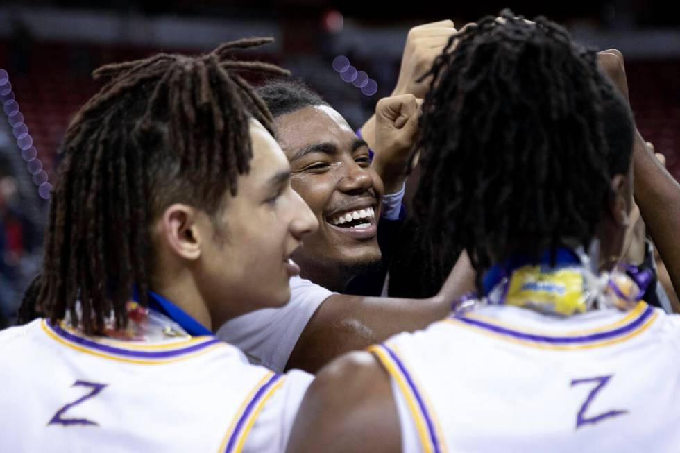 Durango players including Taj Degourville, center, celebrate after winning the NIAA Class 5A bo ...