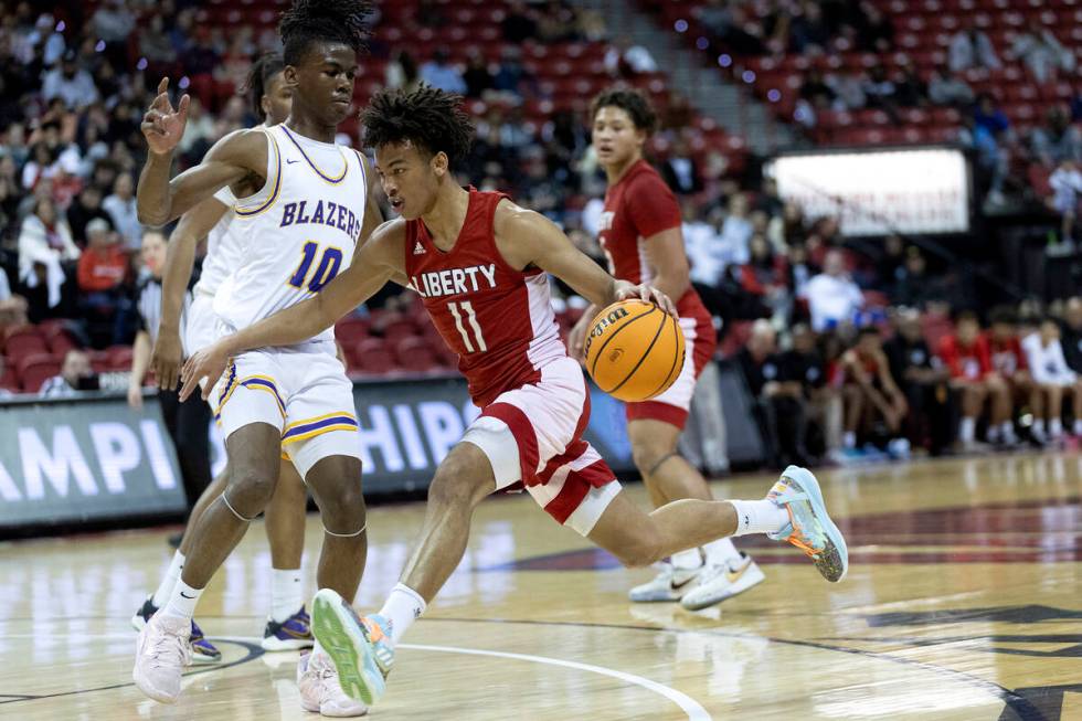 Liberty’s Dedan Thomas (11) drives around Durango’s Tylen Riley (10) during the f ...