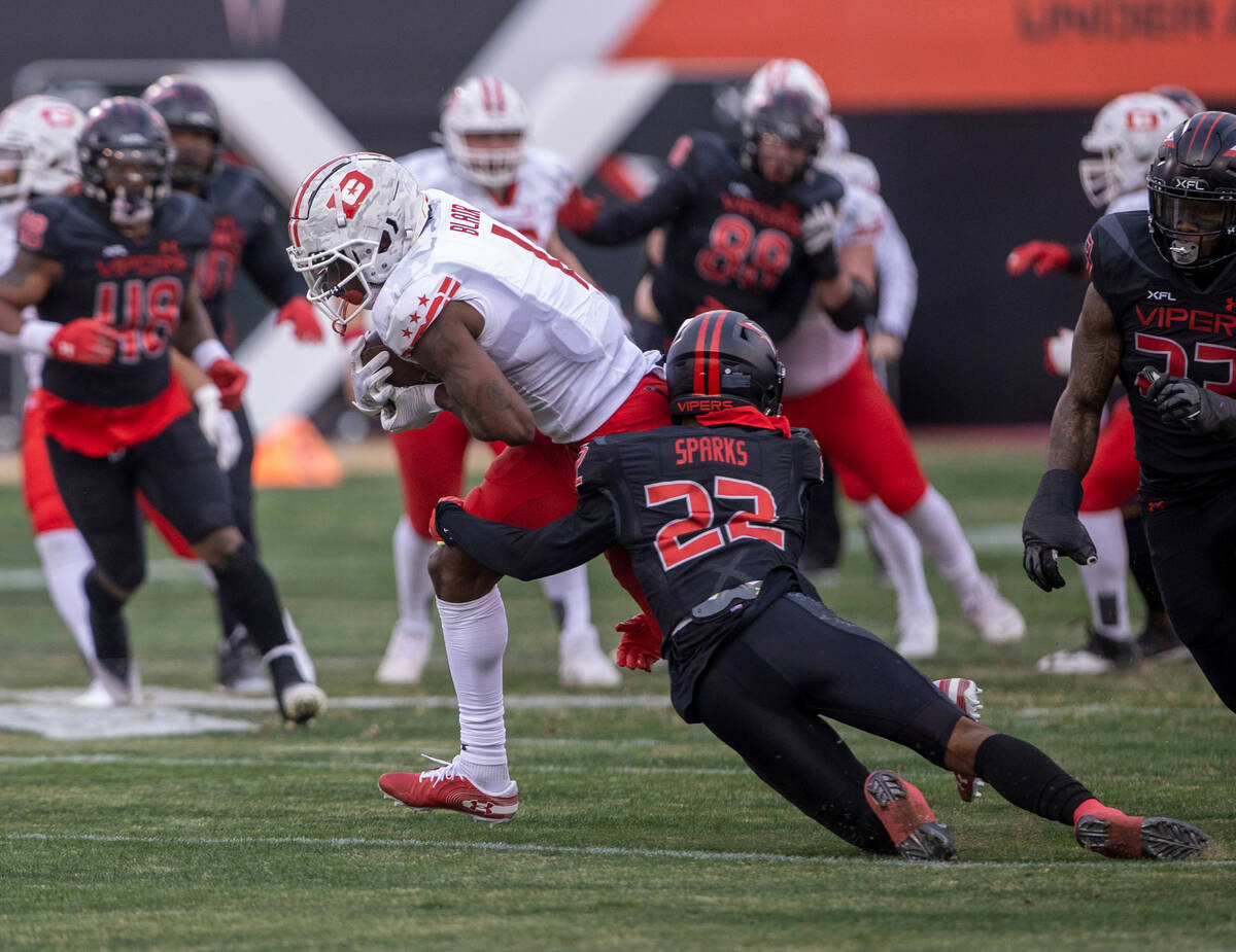 Vegas Vipers defensive back Adam Sparks (22) tackles DC Defenders wide receiver Chris Blair (1) ...