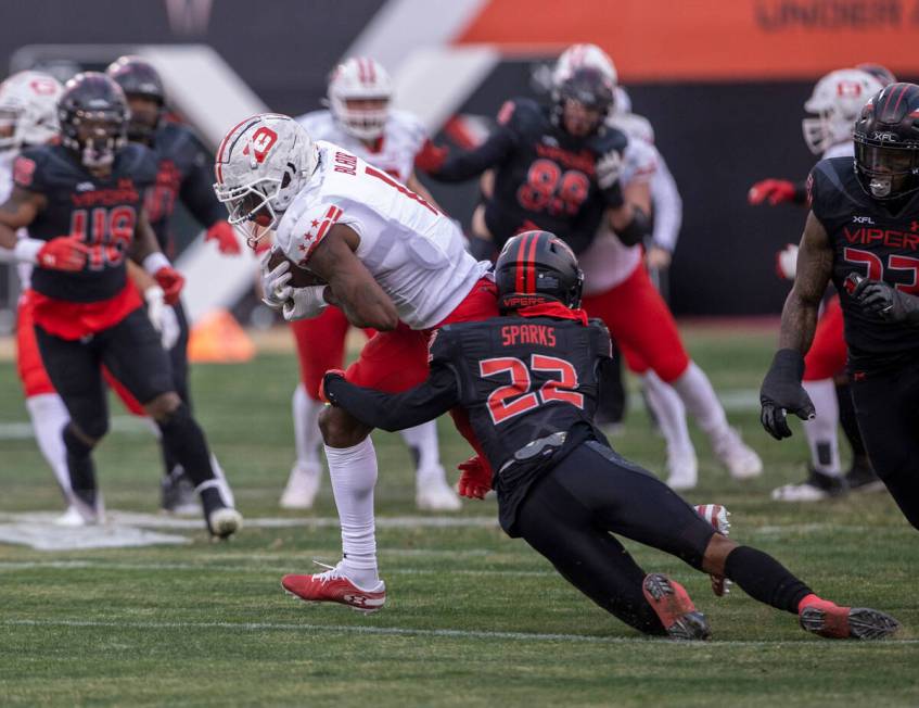 Vegas Vipers defensive back Adam Sparks (22) tackles DC Defenders wide receiver Chris Blair (1) ...