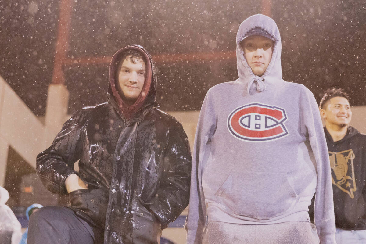 Fans brave the rainy downpour during the second half of an XFL football game between the Vegas ...