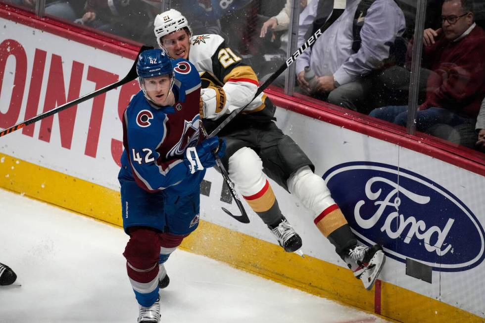 Colorado Avalanche defenseman Josh Manson (42) checks Vegas Golden Knights center Brett Howden ...