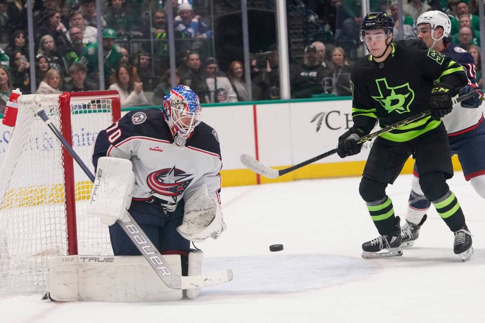 Columbus Blue Jackets goaltender Joonas Korpisalo (70) defends the goal as Dallas Stars center ...