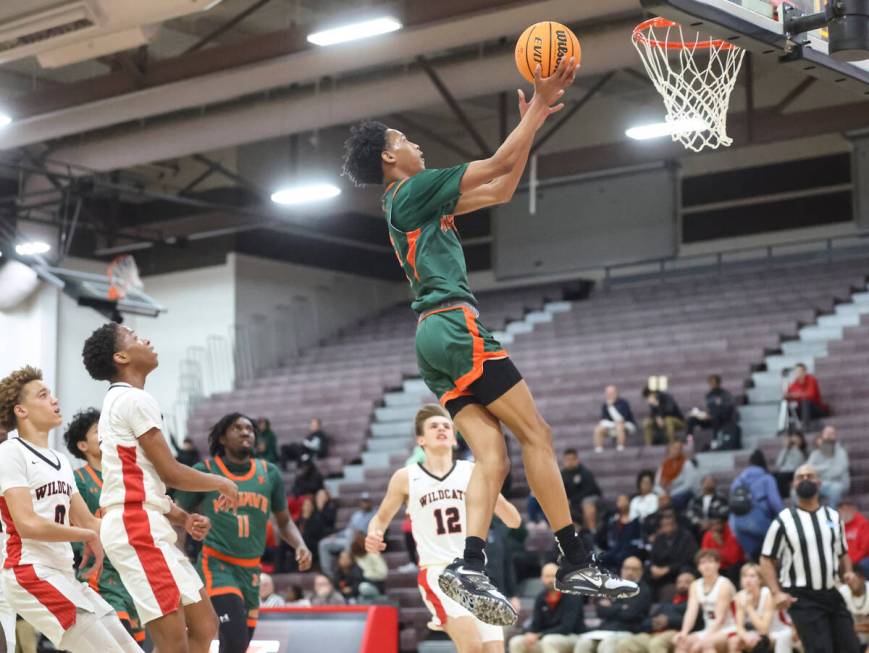 Mojave's C.J. Shaw (3) lays up the ball against Las Vegas during the first half of a basketball ...