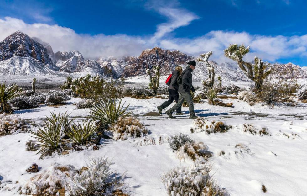 Visitors Andreas and Heidi Dornauf of Germany make their way to a viewpoint ridge overlooking t ...