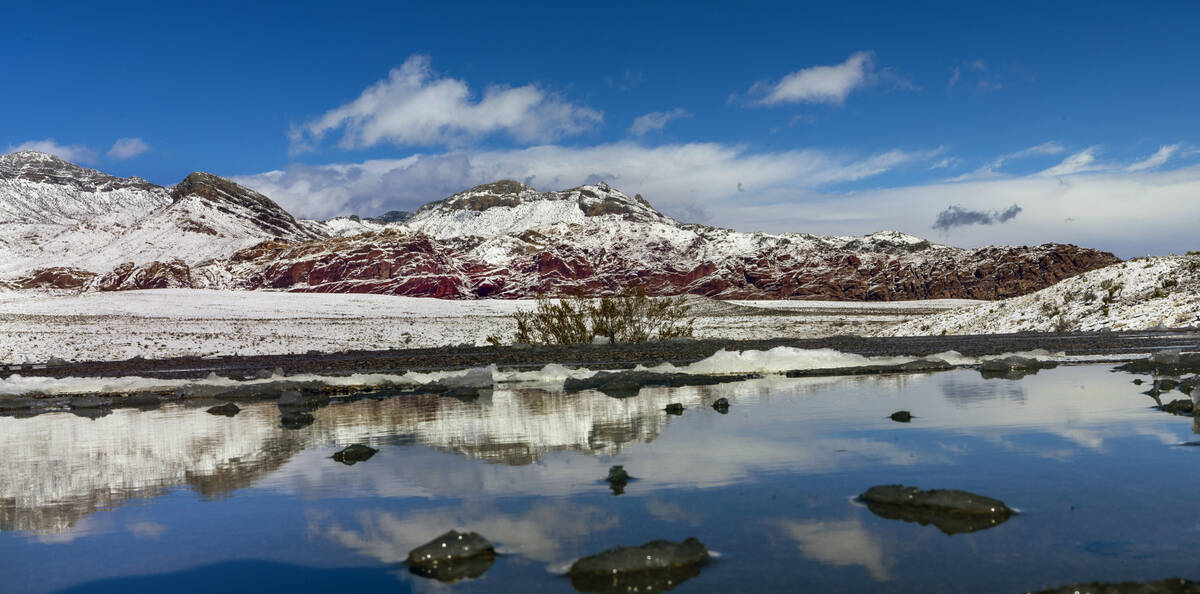 Snowmelt puddles in the overlook area about the Red Rock Canyon National Conservation Area with ...