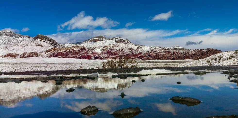 Snowmelt puddles in the overlook area about the Red Rock Canyon National Conservation Area with ...