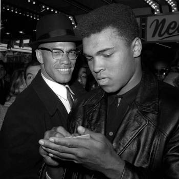 Ali speaks with Malcolm X in 1964 after joining the Nation of Islam. (The Associated Press)