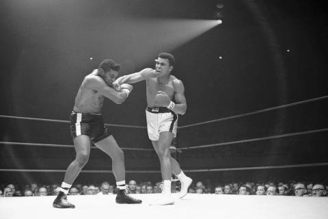 Muhammad Ali moves in with a series of smashes to the face of challenger Floyd Patterson in the ...