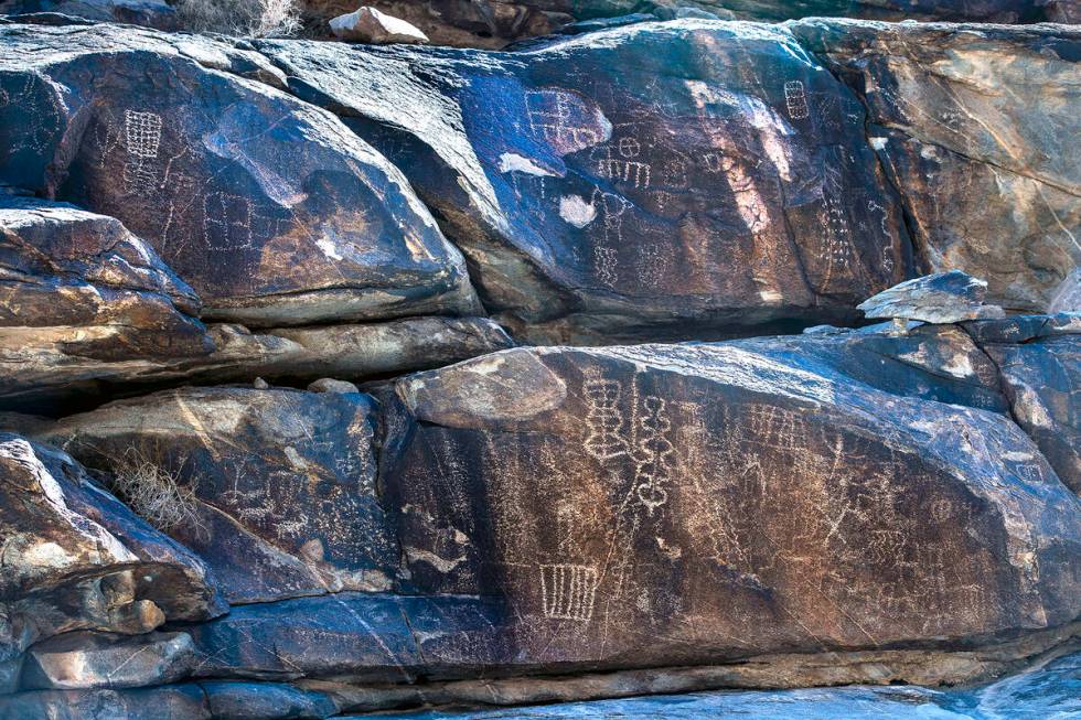 Native American petroglyphs line the rock walls along the canyon bottom in Hiko Springs. (L.E. ...