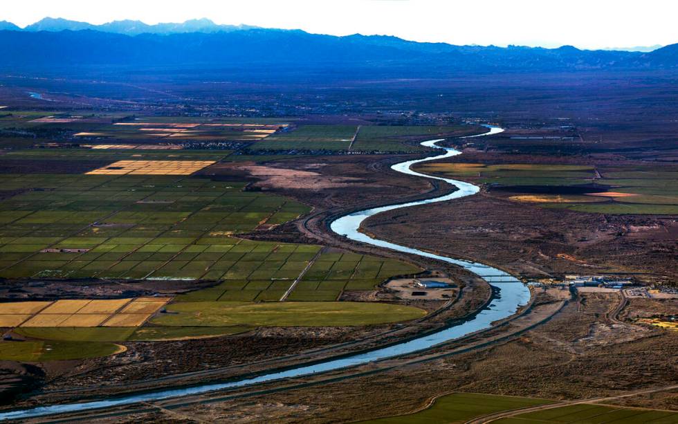 Morning lights Bullhead City, left, and Laughlin farm fields along the meandering Colorado Rive ...