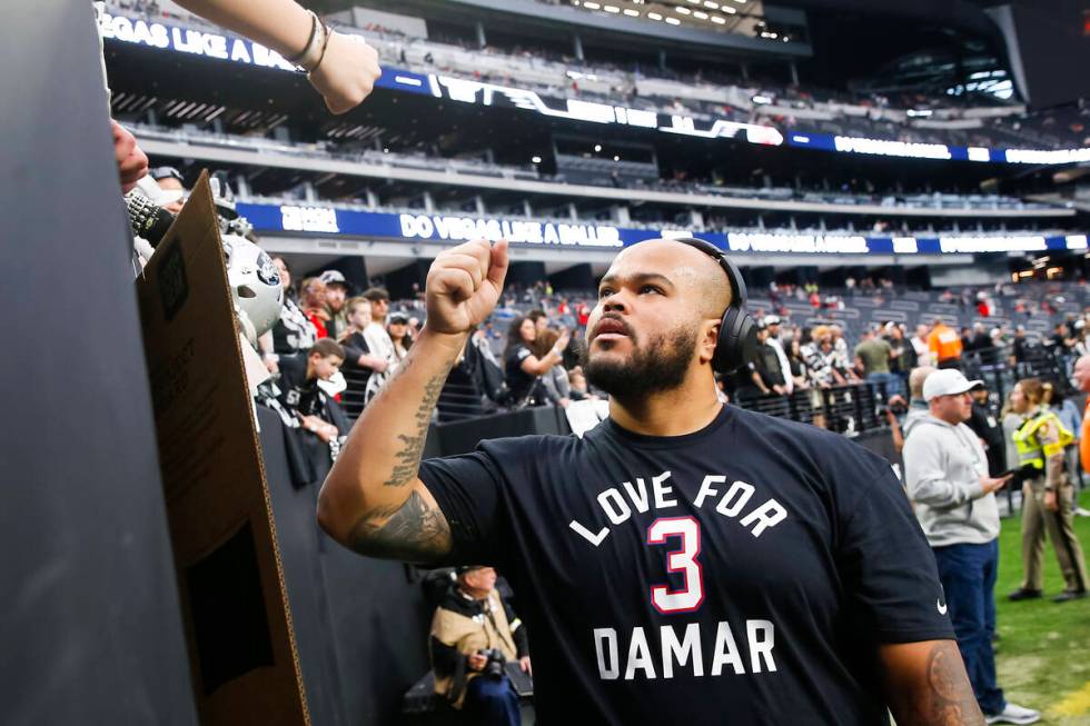 Raiders offensive lineman Jermaine Eluemunor greets fans before an NFL game at Allegiant Stadiu ...