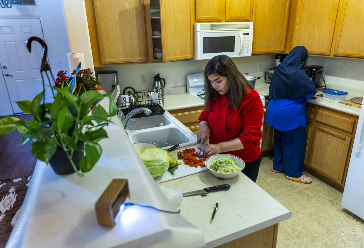 Shabana and her mother-in-law, Nazanin, prepare dinner in their apartment on Tuesday, Feb. 28, ...